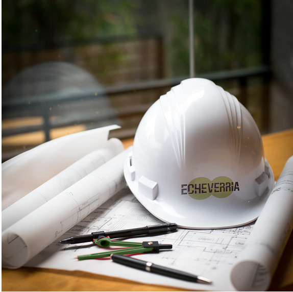 Echeverría branded hard hat on blueprints