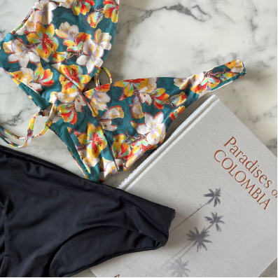 Providencia swimwear flat lay with Paradises of Colombia book
